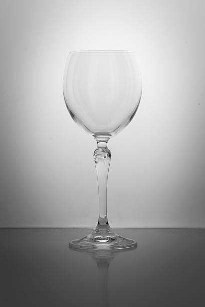 istock empty crystal glass with long stalk isolated on gray background 547132162