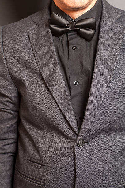 istock Man wearing a gray suit and black bow tie 547132174
