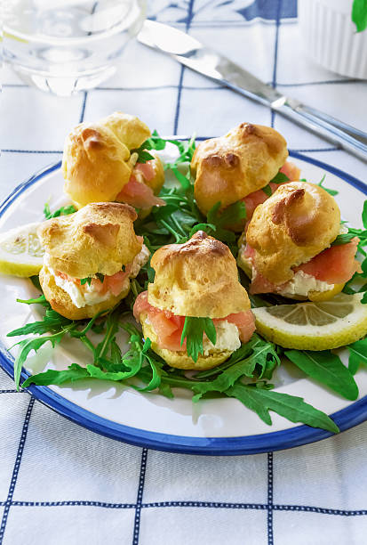 Cocktail snack. Savory Pate a Choux (Savory Puffs) with Smoked Salmon stock photo