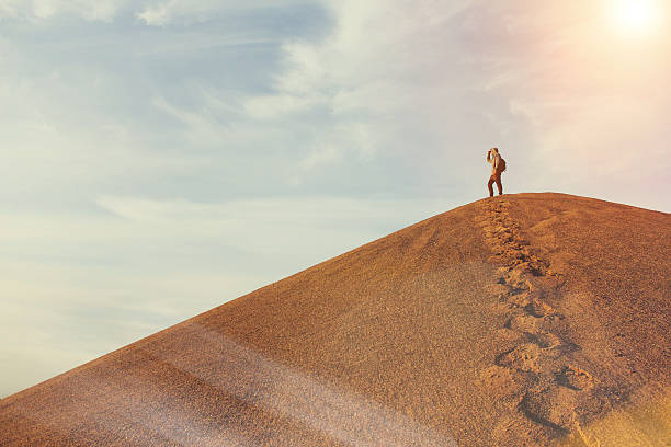 Man on top of a dune in the desert