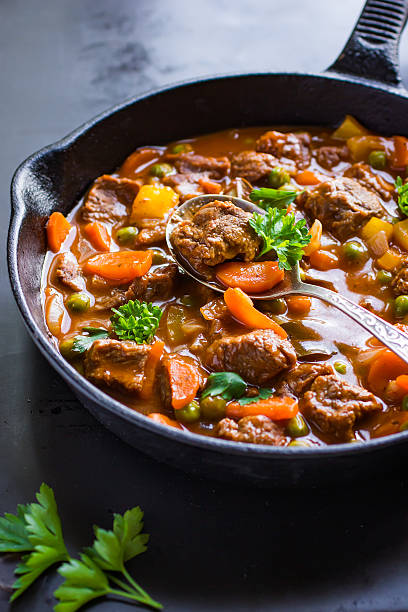 beef stew with vegetables beef stew with vegetables on dark background, beef stew stock pictures, royalty-free photos & images