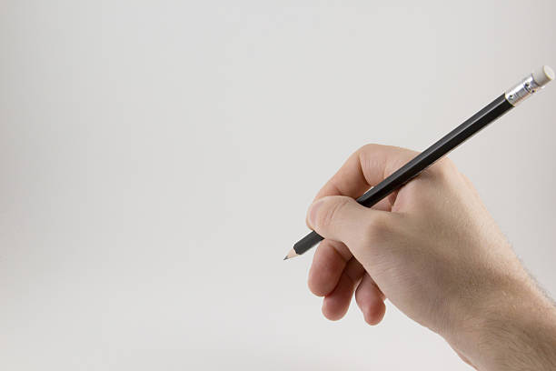 istock Hand with a pencil on a white background 547135150