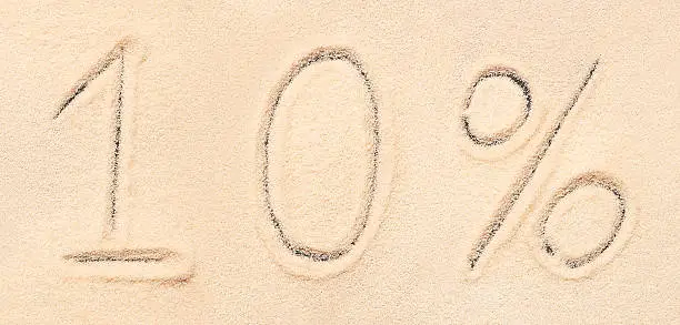 Photo of lettering written on sand