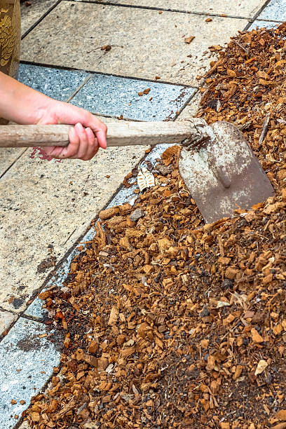 istock man worker using hoe equipment on the soil clay dirt 547135364