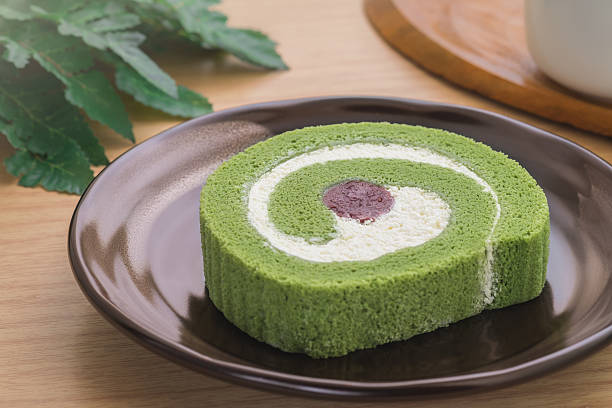 istock Green tea roll cake with red bean on plate 547136762