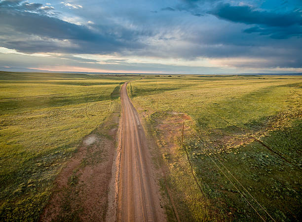 ranch road over Wyoming prairie ranch road over prairie in southern Wyoming near Colorado border - aerial view wyoming stock pictures, royalty-free photos & images