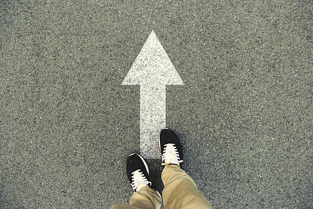 istock Forward arrow painted on an asphalt road 547137480