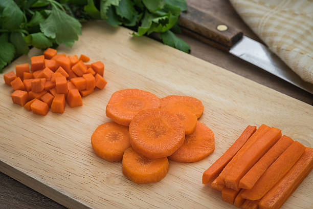 istock Carrots slices on wooden cutting board 547138700
