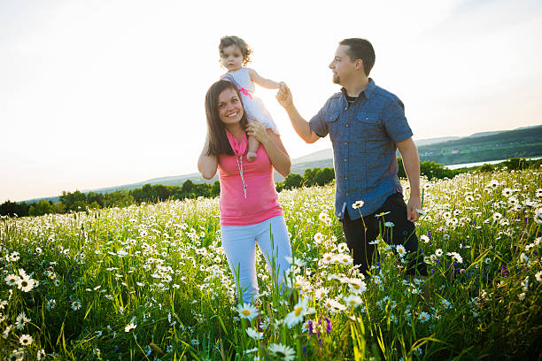 istock happy joyful family with daughter daisy field 547138764