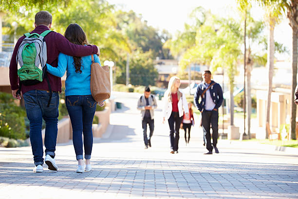 istock Student Couple Walking Outdoors On University Campus 547139206