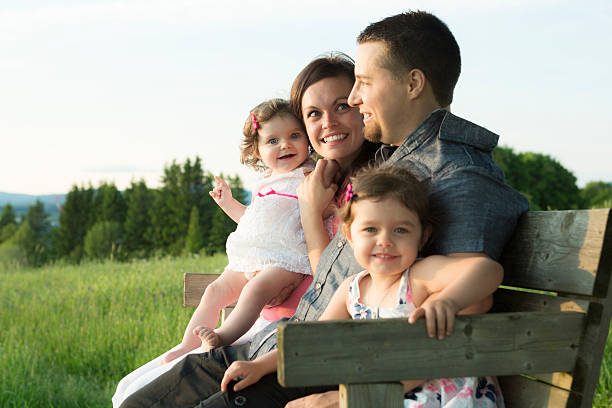 istock family sit on bench at sunset 547139352