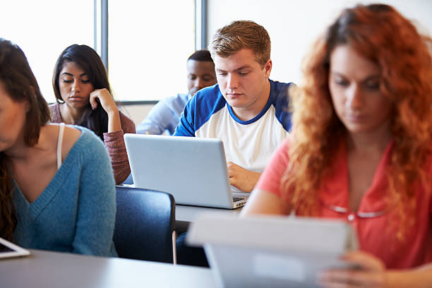 istock Male University Student Using Laptop In Classroom 547139494