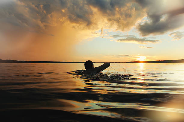 Strong man is sailing into the sunset