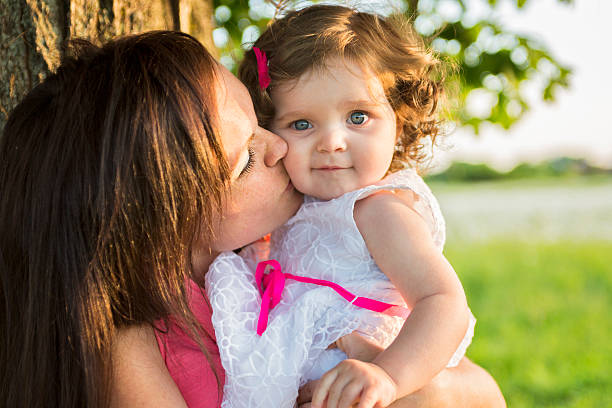 istock happy joyful mother with daughter daisy field 547139526