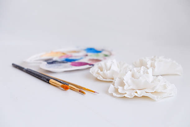 istock abstract still-life with edible white rose bud and paintbrushes 547139932