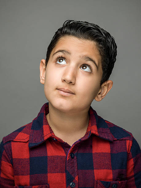 istock Portrait of thinking young boy 547141286