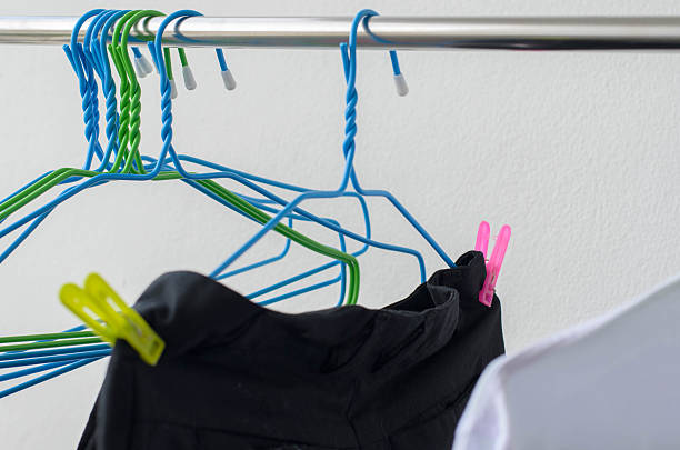 istock black trousers and hanger drying on a clothes line.. 547142196