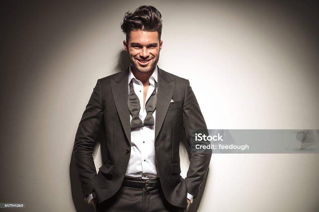 Happy young elegant business man smiling Happy young elegant business man smiling while holding both hands in his pockets. Beautiful People Stock Photo