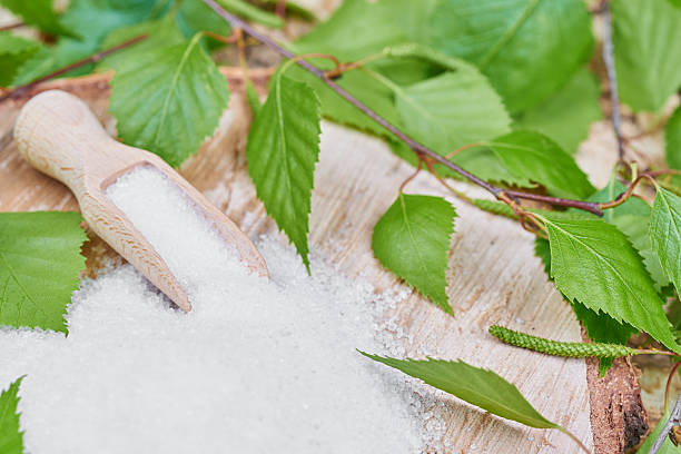Xylitol birch sugar on a birch background