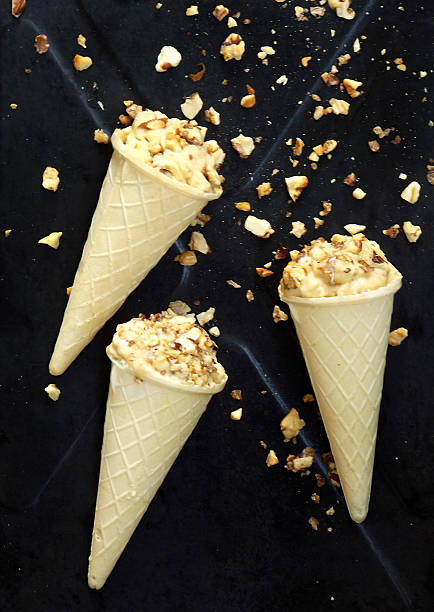 istock caramel ice cream cone topped with caramelized walnuts 547147506