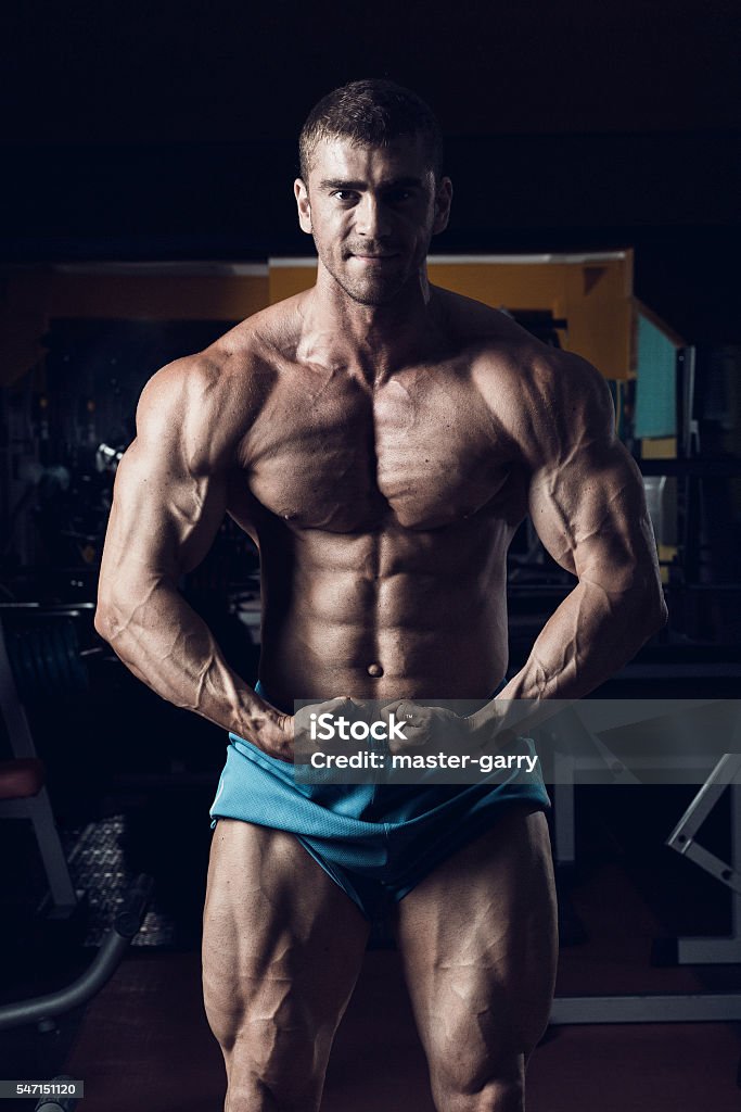 Male bodybuilder, fitness model Male bodybuilder, fitness model trains in the gym Activity Stock Photo