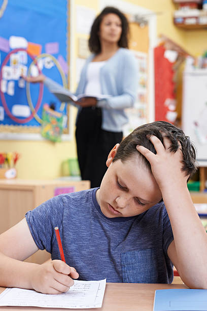 istock Male Elementary School Pupil Struggling In Class 547155076