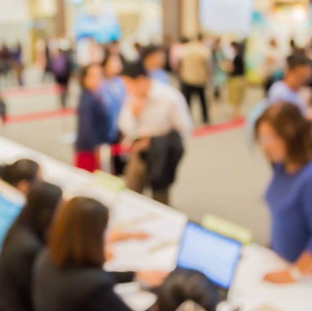 istock Customers and  receptionist with notebook  at counter  in blur  motion 547155214