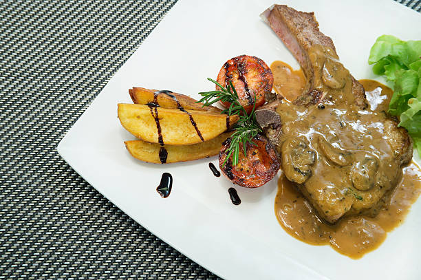 istock Grilled Pork steaks, baked potatoes and vegetable salad 547155474
