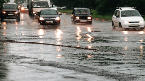istock Car traffic in bokeh when heavy rain drops in concrete 547155548