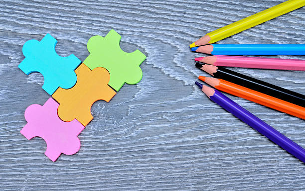 istock color puzzle and crayons on wooden table 547155670