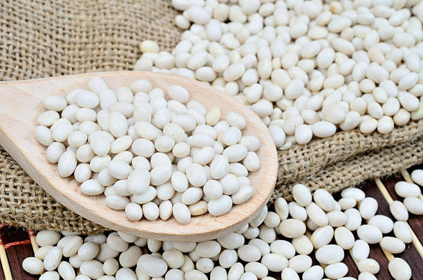 istock white beans in wooden spoon on table 547156780