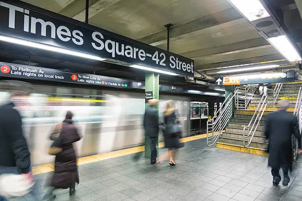 Photo of Commuters at Times Square Subway Station in New York City