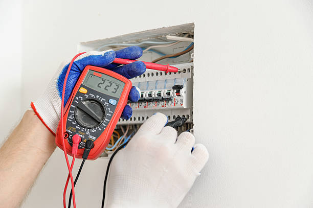 istock Electrician check voltage in electrical fuse box. 547161000
