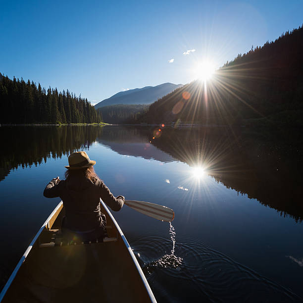 istock Woman canoeing at sunrise 547161176