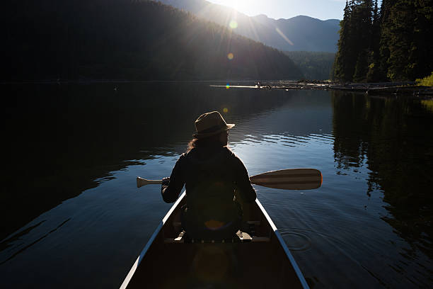 istock Woman canoeing at sunrise 547161982