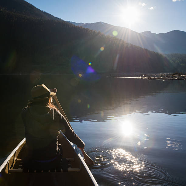 istock Woman canoeing at sunrise 547162152