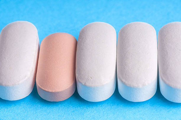 istock Many pills and tablets isolated on light blue background 547164178