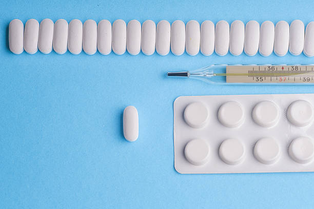 istock Many pills and tablets isolated on light blue background 547164268