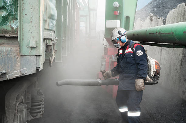 Cleaning of freight cars from coal dust. stock photo