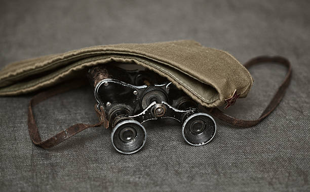 istock Military binoculars and a cap on a dark background, vintage style 547166014