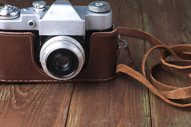 istock Old retro camera on vintage wooden boards abstract background. 547166218