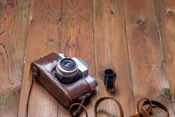 istock Old retro camera on vintage wooden boards abstract background. 547166314