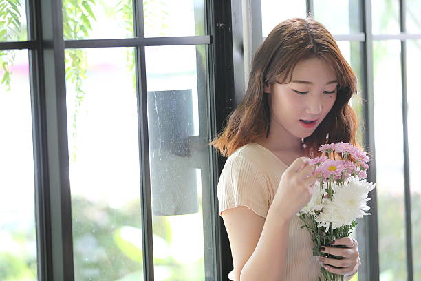 istock Asian girl with flower 547166956