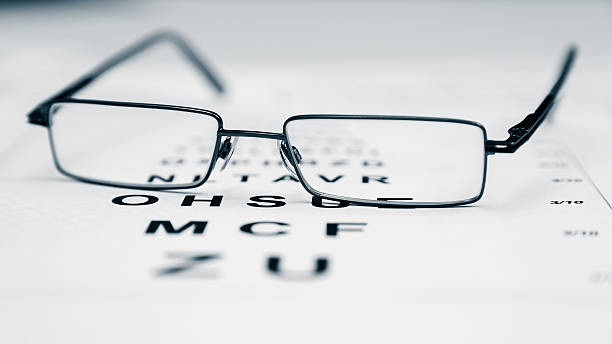 istock Clear Black modern glasses on a eye sight test chart 547168266
