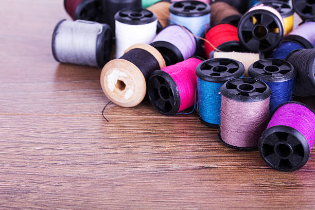 istock Scattered cotton reels on a wooden surface 547169112