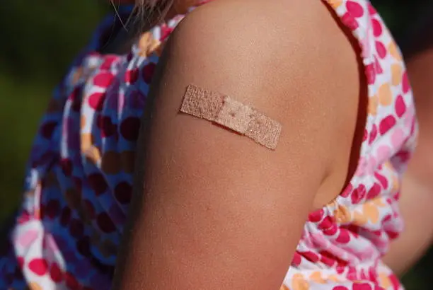 Sticking plaster on child after vaccination shot