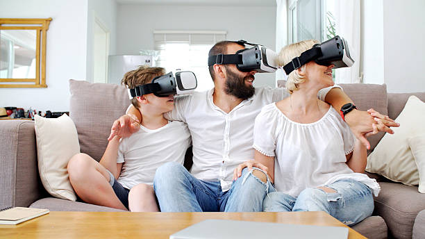istock Family at home playing with virtual reality headsets. VR. 547170344