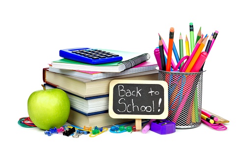 Back to school supplies on blackboard background.