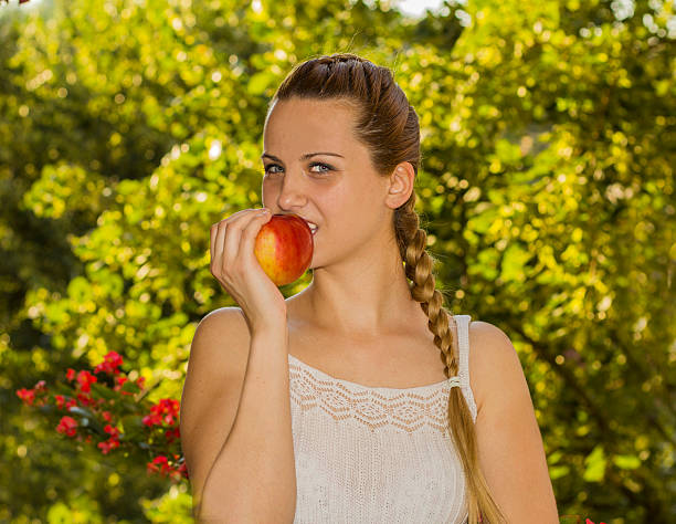 istock Beautiful Healthy Woman eating red apple. 547199184