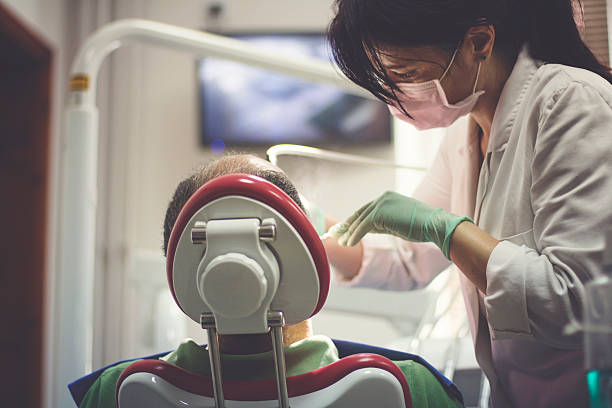 dentist examines the teeth of patient - dentist dental hygiene dental assistant dentist office imagens e fotografias de stock